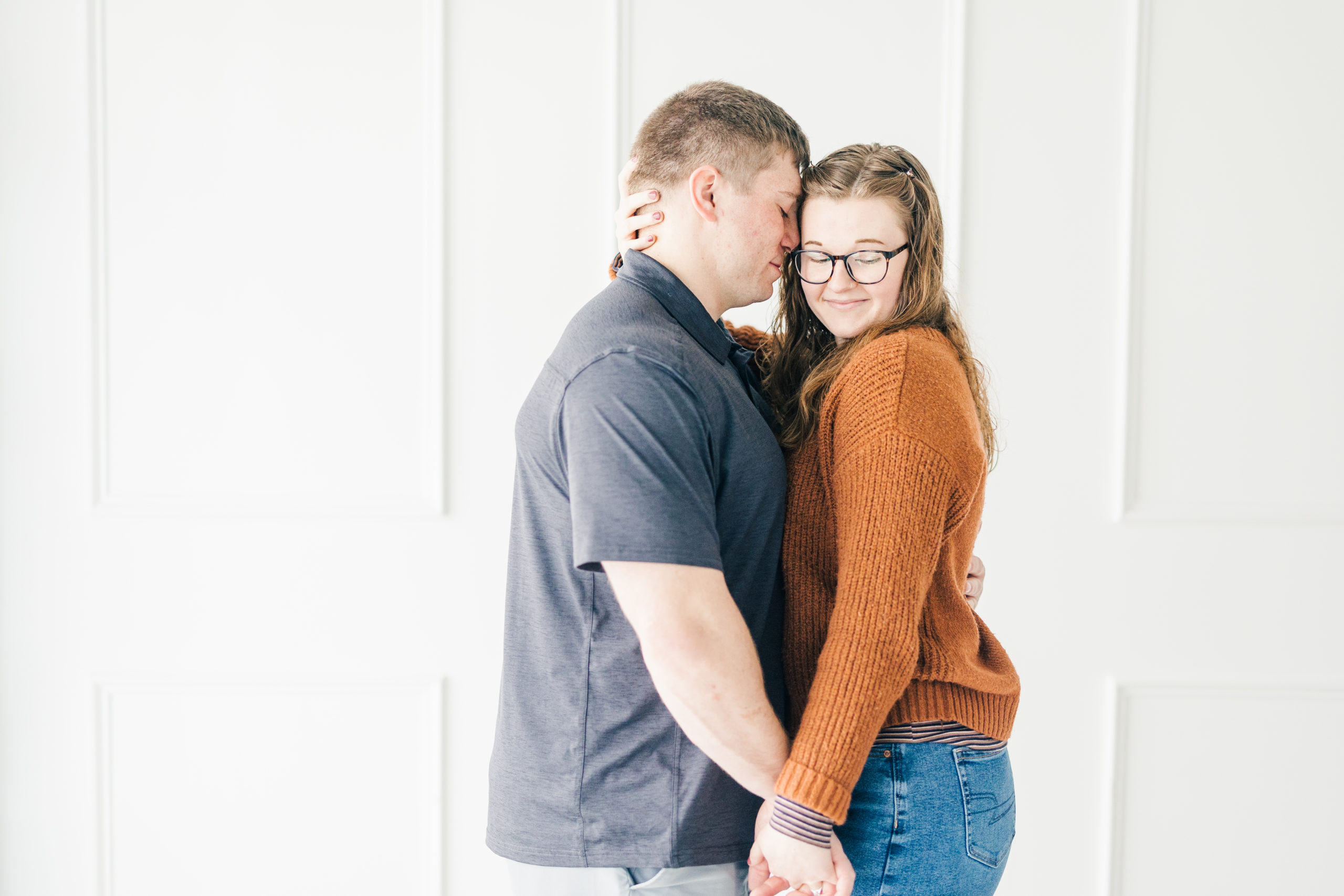 Clean white background with engaged couple