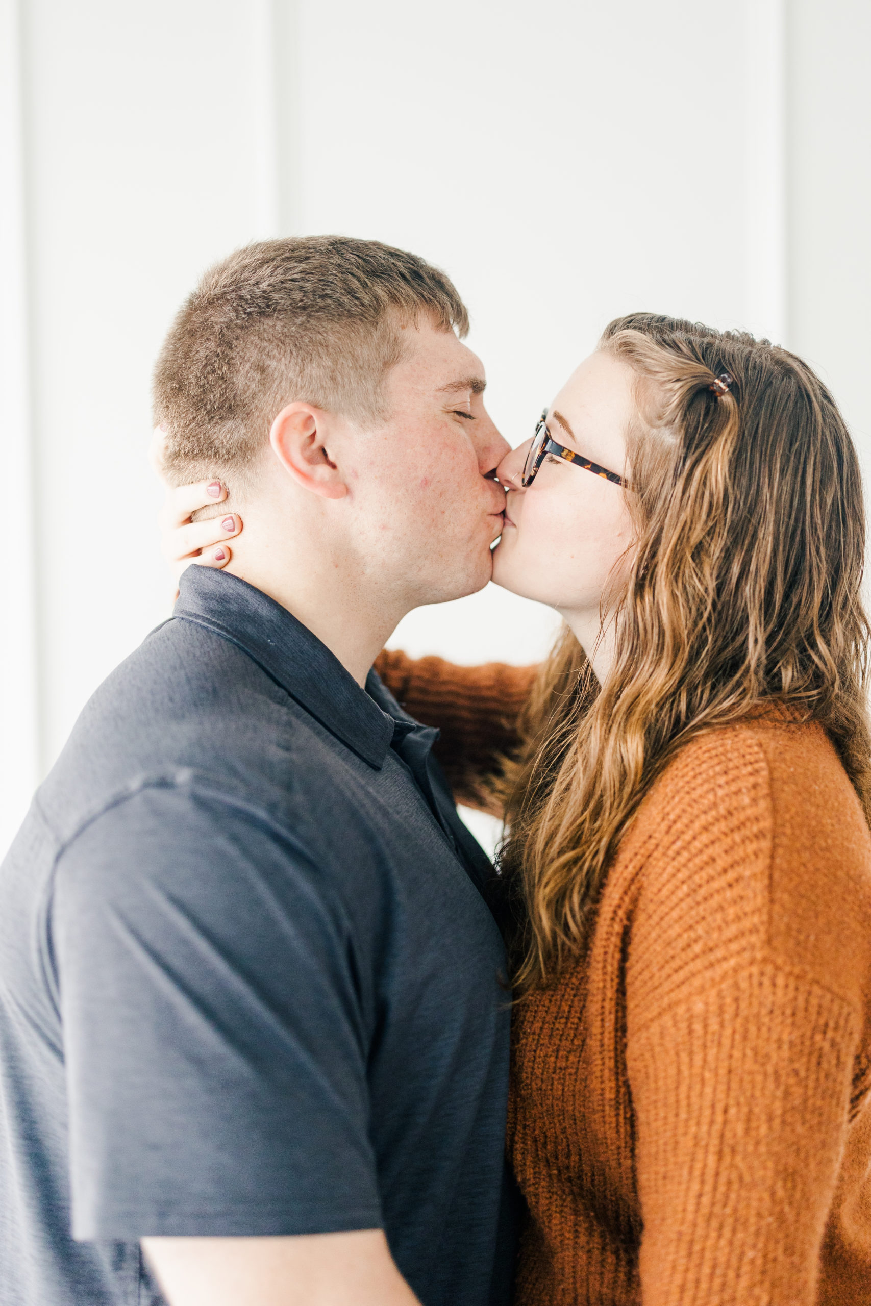 Studio session with engaged couple kissing