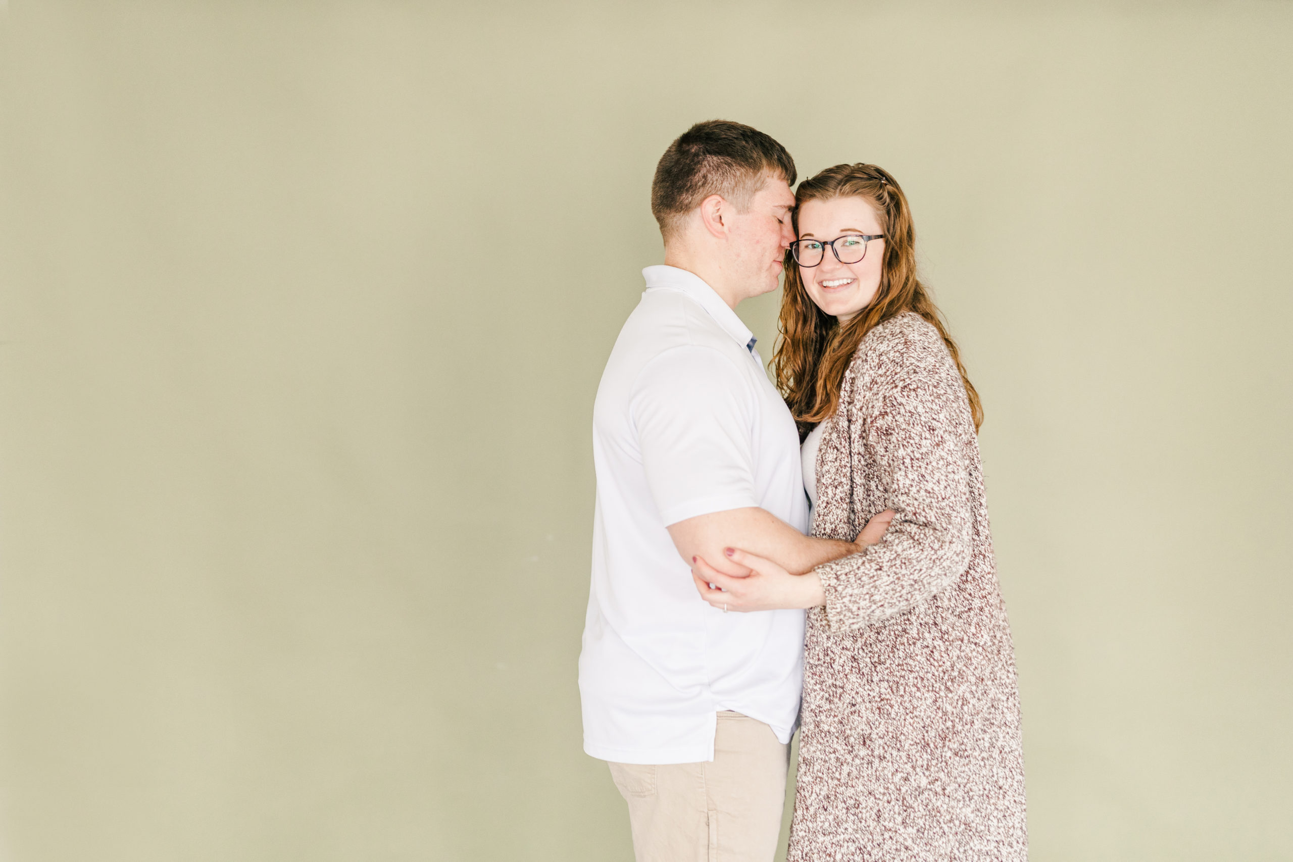 Studio session with engaged couple smiling