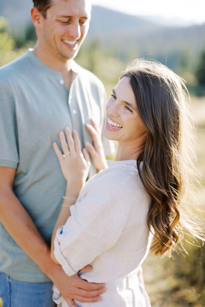 Man holding woman close with sun flare over Brainard Lake