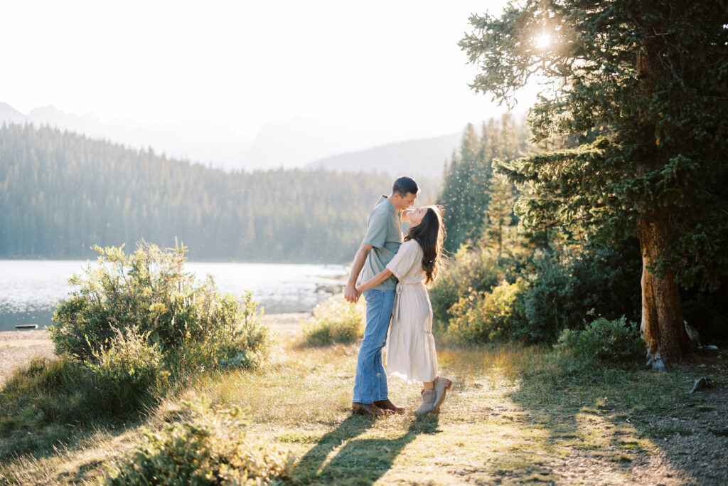 Couple holding hands and laughing at Brainard Lake near Denver, Colorado