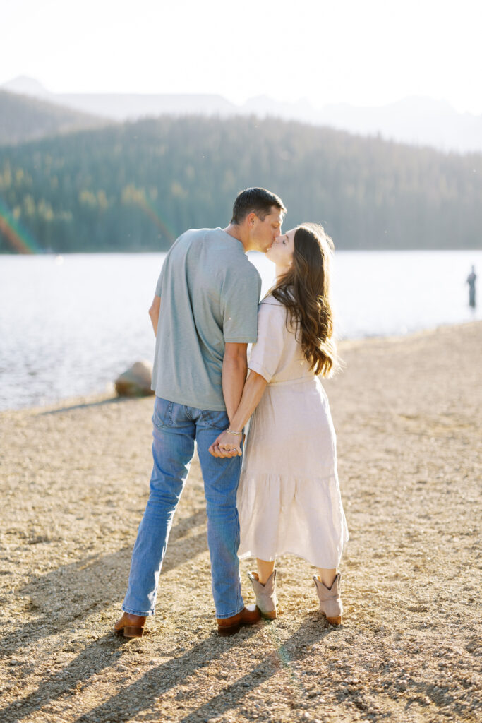 Couple kissing with Brainard Lake reflections in the background