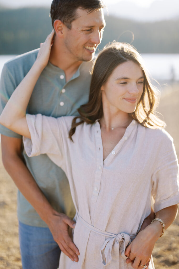 Woman leaning on her partner during sunset mountain session