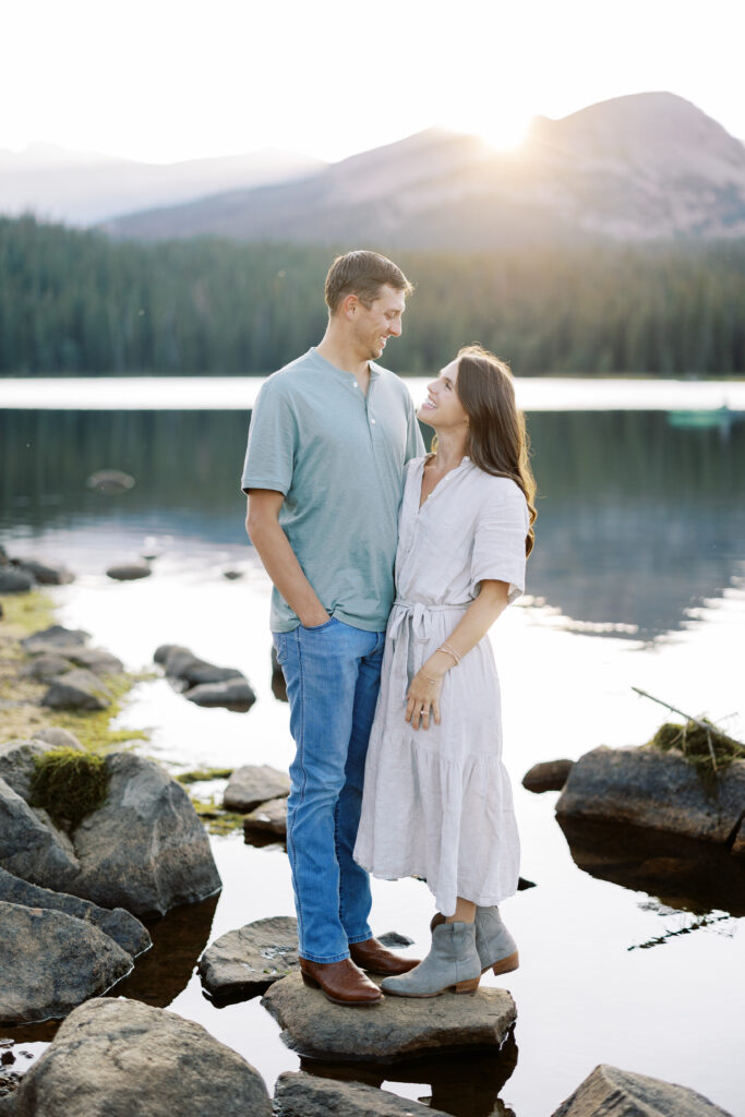 Couple smiling at Brainard Lake during golden hour in the Colorado mountains