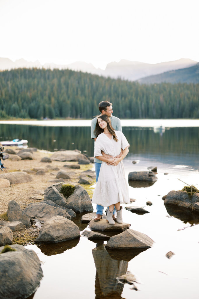 Couple with their dog at Brainard Lake during golden hour in the Colorado mountains