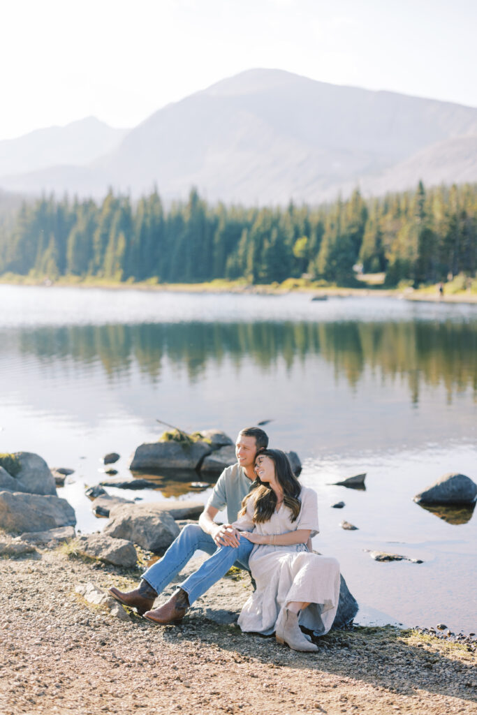 Romantic golden-hour portrait of couple with Colorado peaks in the distance