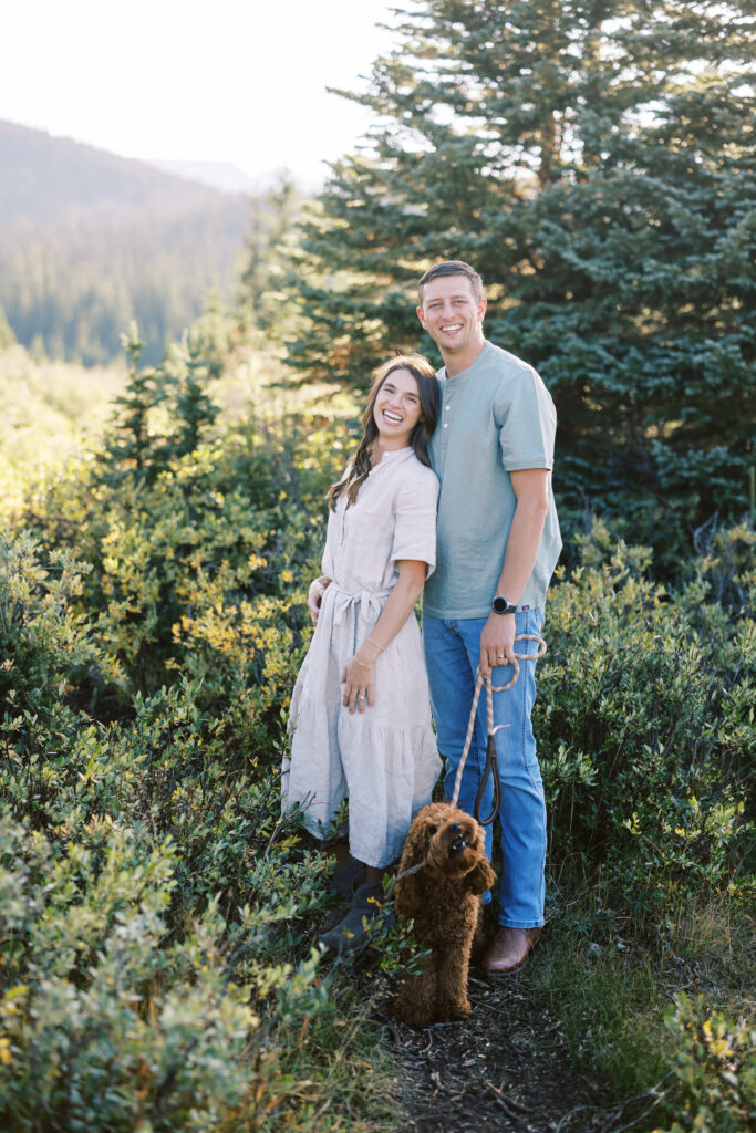 Couple twirling in the sunlight by mountain lake in Colorado