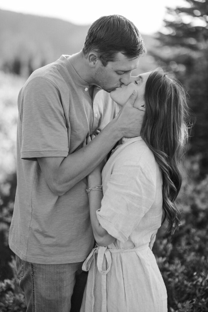 Man and woman embracing with Colorado peaks behind them