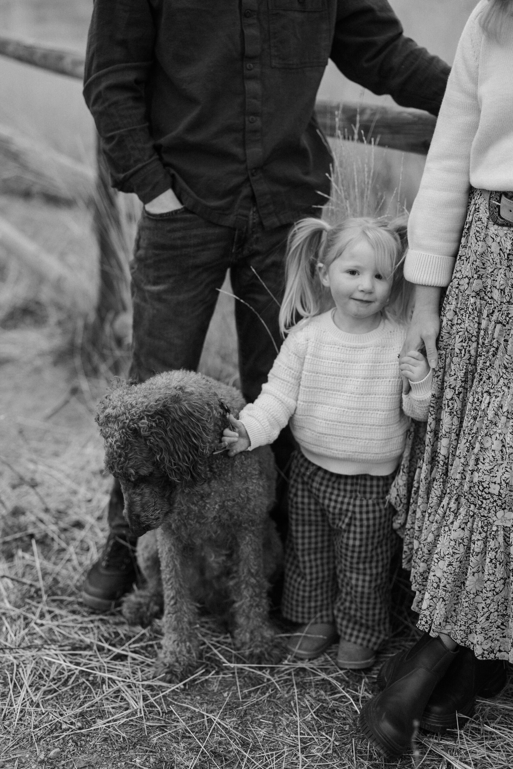 Family portrait taken outdoors with natural light and mountain views at South Boulder Peak Trailhead.